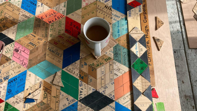 Wall art created from wooden rulers showcases a parquet design