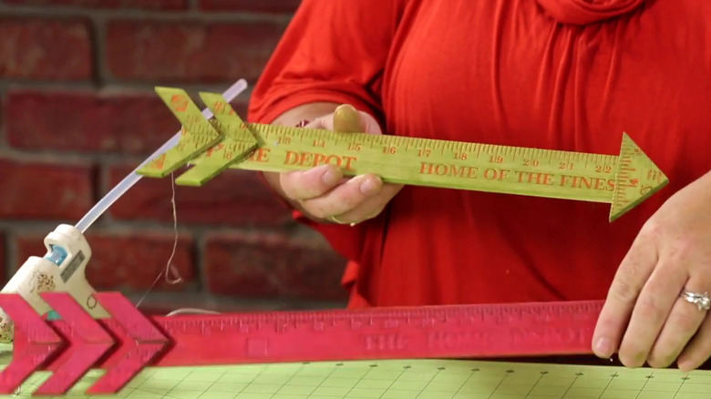 Crafter Lori Allred demonstrates how to create decorative wooden arrows using old yardsticks.
