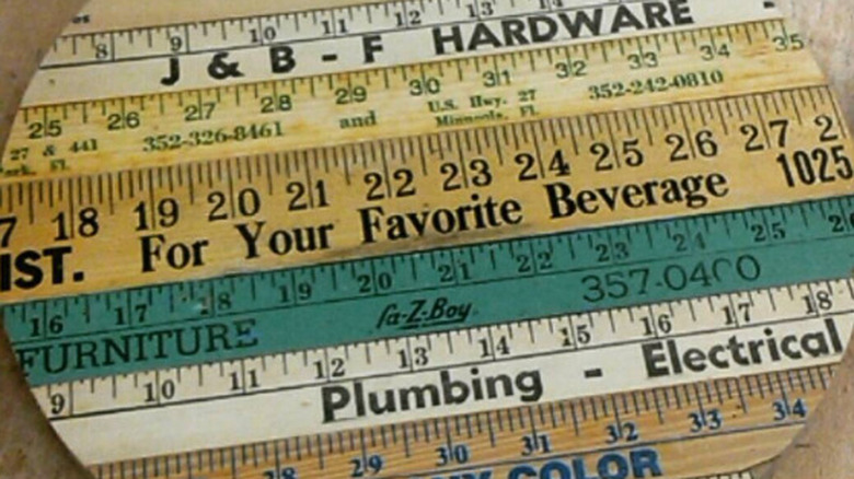 A variety of antique wooden rulers create the top for a round side table