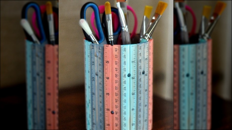 A desk caddy/organizer created using wooden rulers