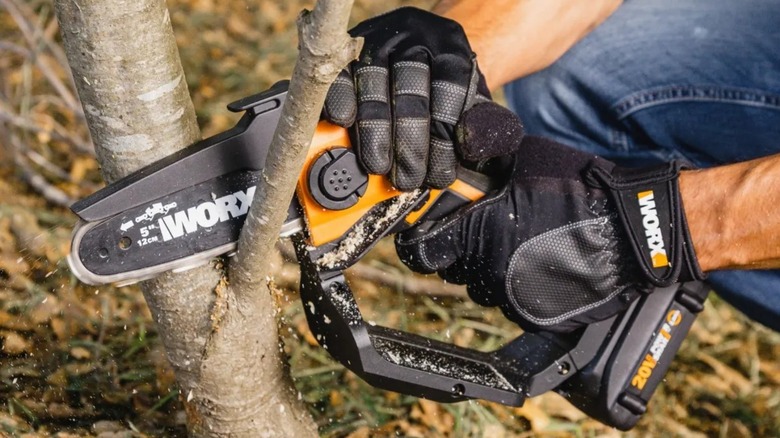 Worx Cordless Pruning Saw being used on a small tree