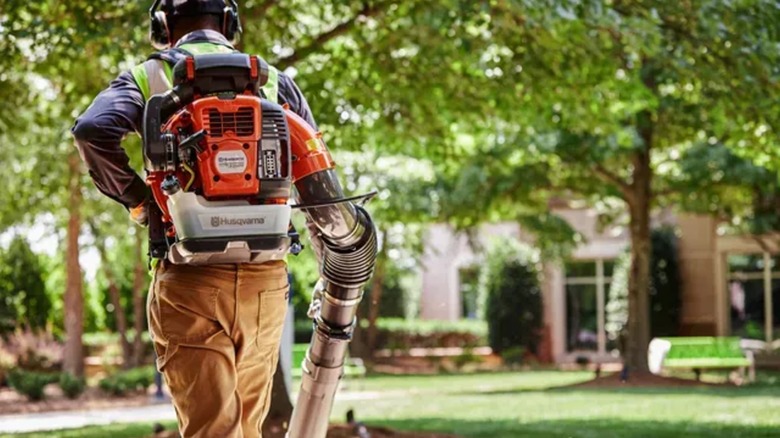 Husqvarna 150BT 51cc Gas Backpack Leaf Blower on man's back