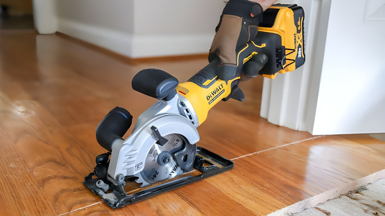a person using the DEWALT ATOMIC cordless circular saw