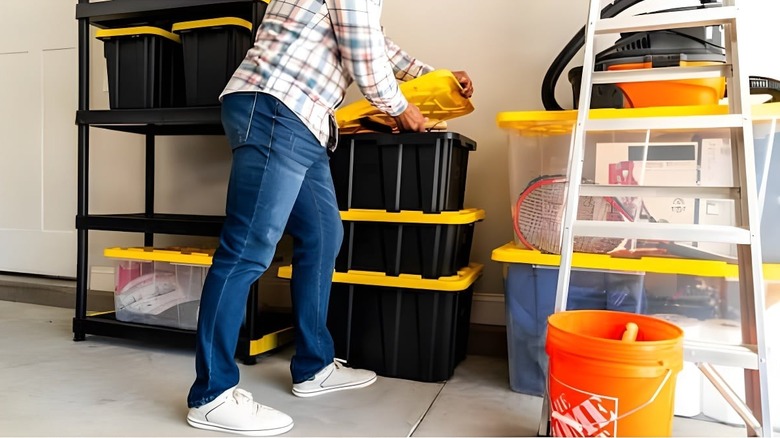 a person stacking HDX Tough Storage Tote