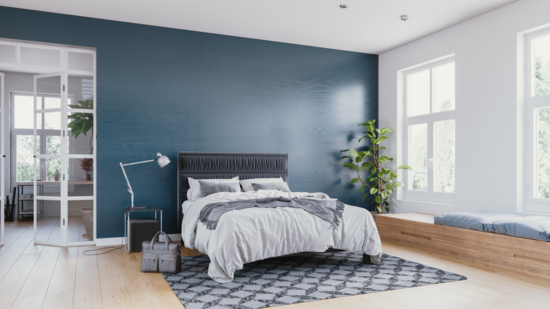 Teal-colored accent wall in a bedroom