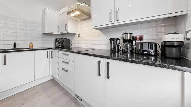 White kitchen cabinets with small appliances on countertop