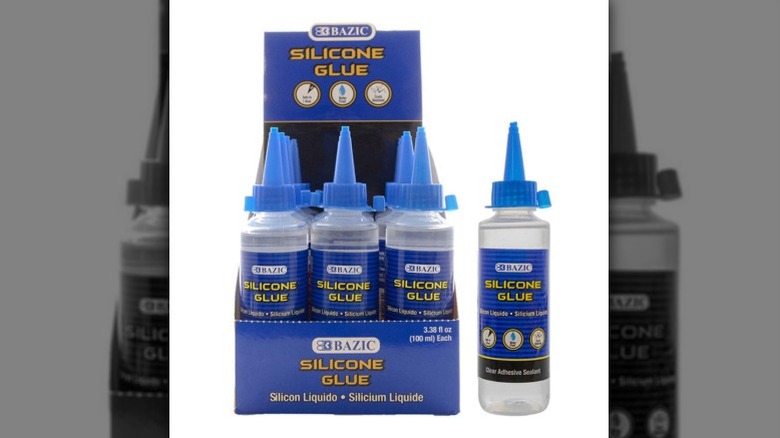 Carton of BAZIC brand silicone glue with one bottle set to the side.