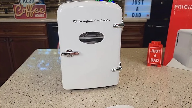 White Frigidaire minifridge on a countertop.