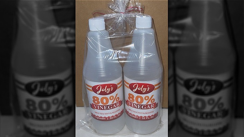 Two bottles of Joly's 80% vinegar cleaner wrapped in a plastic bag.