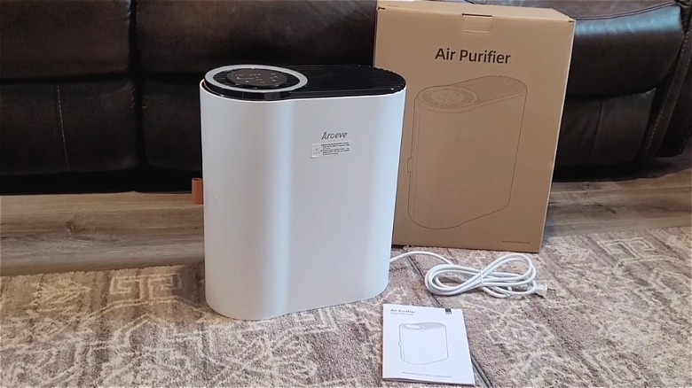 Aroeve brand air purifier unboxed and sitting on Living room floor.