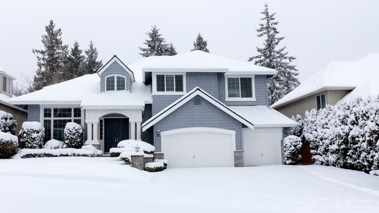 The front of a large house on a snowy winter's day