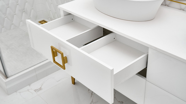 Recently installed white drawers of a bathroom vanity