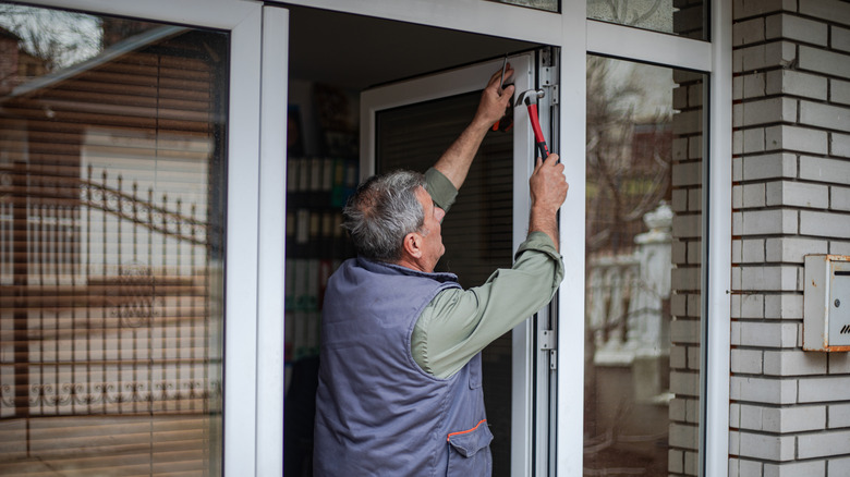 Man installing new doors in a frame