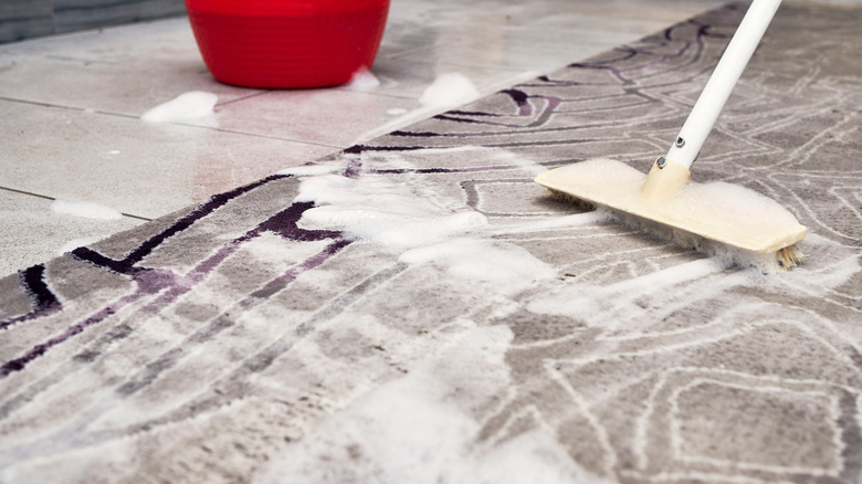 Mopping the floor with a broom