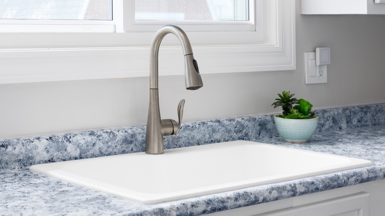 Closeup of blue marble countertop around a sink