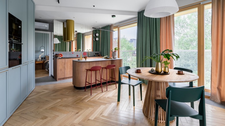 Kitchen with light blue cabinets and green and beige curtains