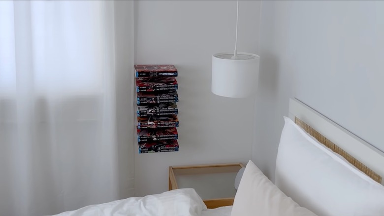 VARIERA Pot lid organizer on wall with books