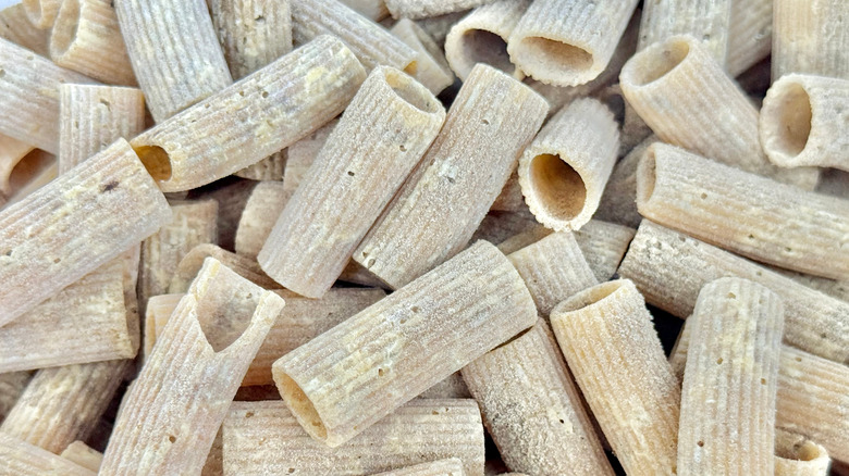 Dried pasta with clear marks of spoilage due to pantry moths