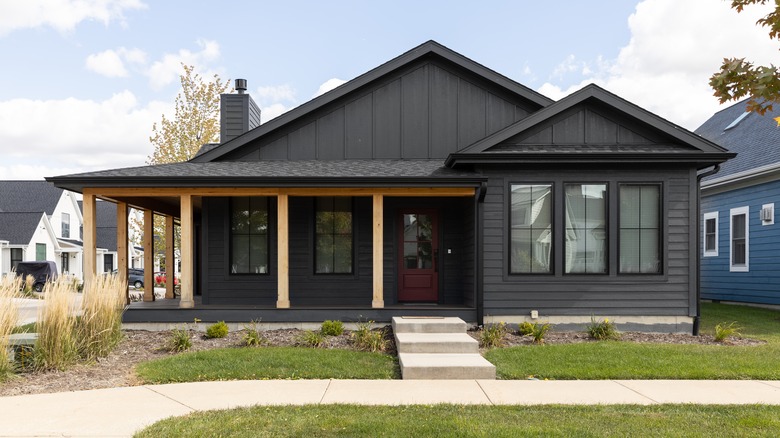 black ranch home maroon door