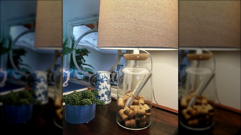 Corks in a clear glass lamp on a table