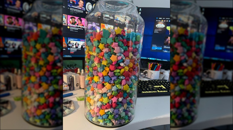 Origami stars in a lamp base on a desk