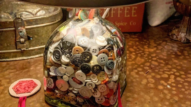 Vintage buttons in clear lamp base