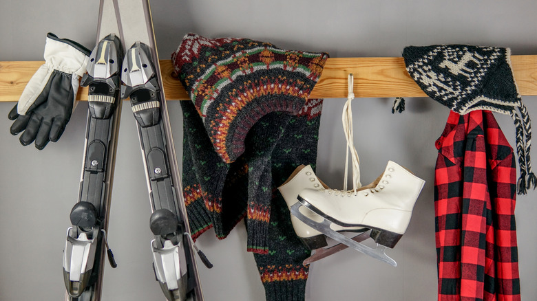 Winter sports gear on a rack