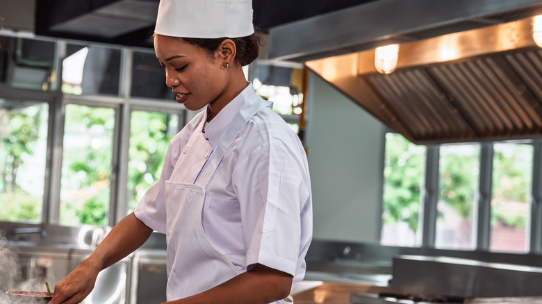 A chef preparing a meal in a professional kitchen