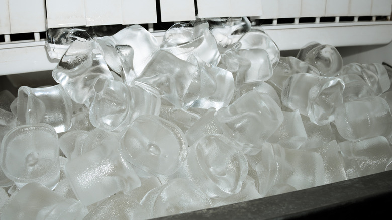 Melting ice cubes sitting in a countertop ice cube tray
