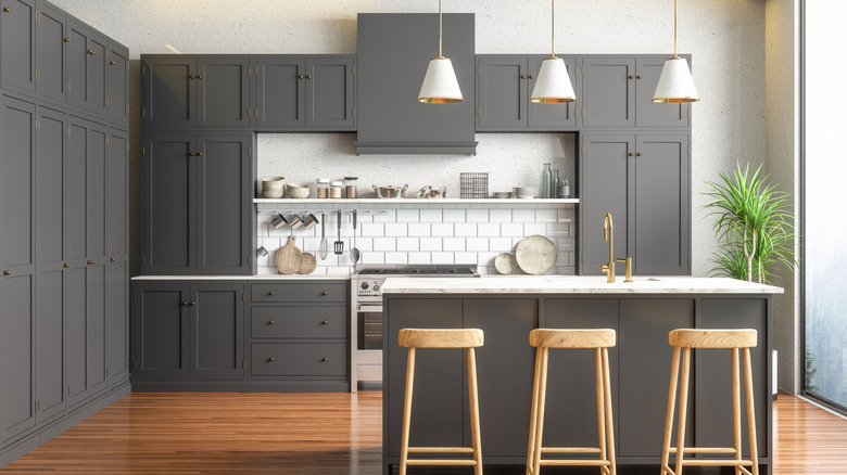 The interior of a gray and white kitchen.