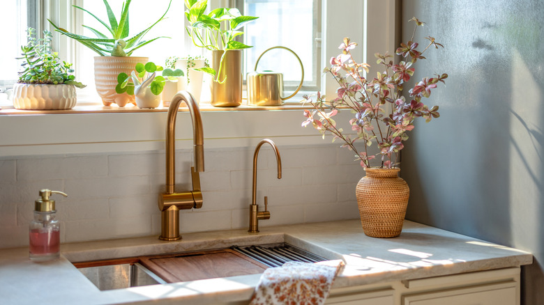 A kitchen sink situated in front of a window.