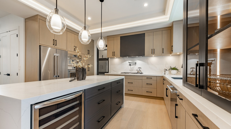 A kitchen interior with white marble countertops.