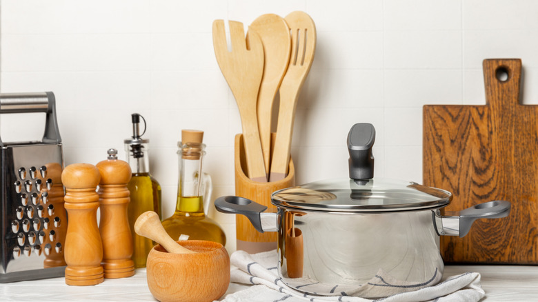 A selection of cooking pots and utensils on a kitchen counter