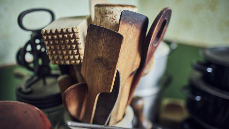 Collection of kitchen utensils and discolored wooden spatulas.