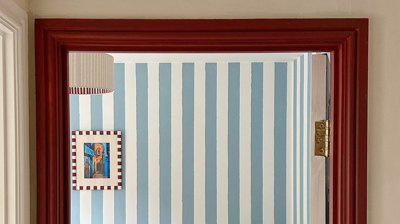 A door frame painted in a dark burgundy wood stain.