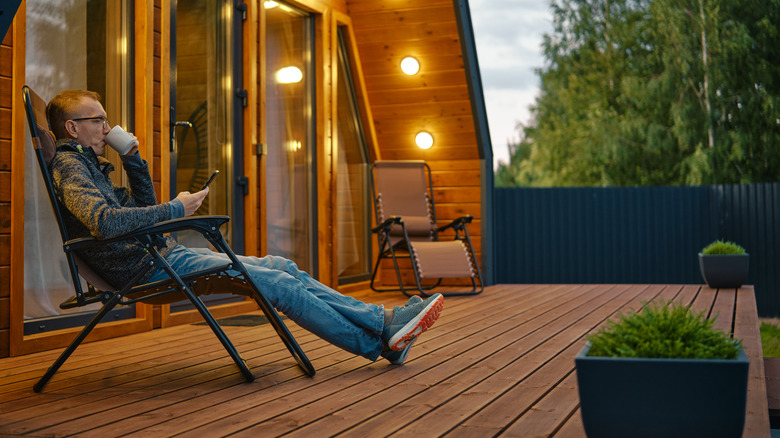 A man relaxes on his patio