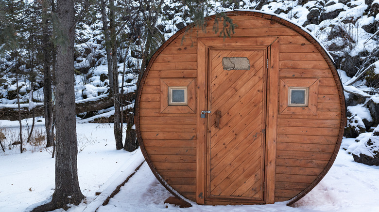 A circular outdoor wooden sauna.
