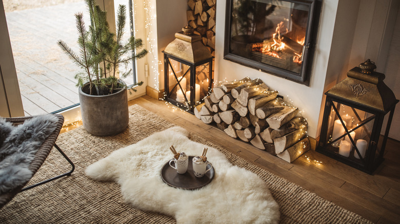 Coffee mugs sitting on a faux fur rug in a living room