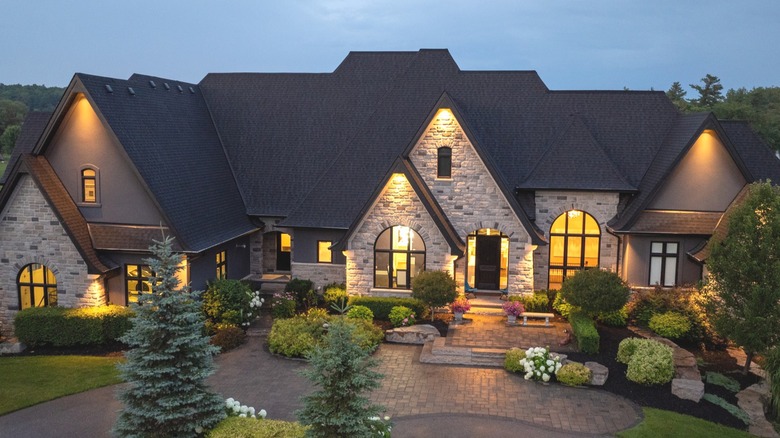 Aerial view of a luxury house lit up in the evening