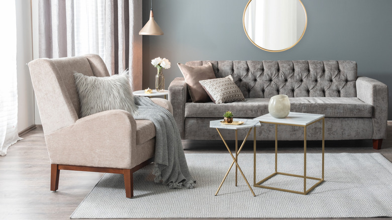 Living room with velvet sofa, faux fur pillow, and textured area rug