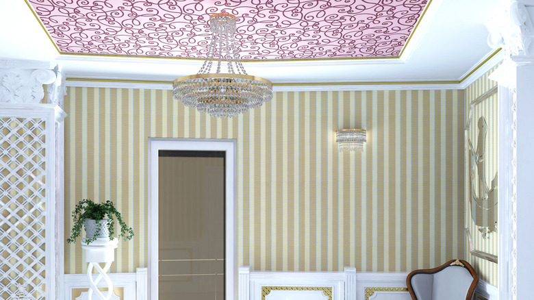 A ceiling with patterned wallpaper