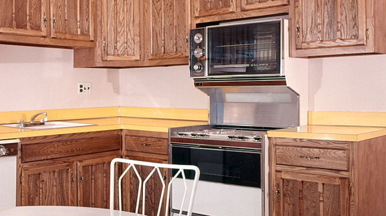 Mustard yellow laminate countertops in a 1970s kitchen.