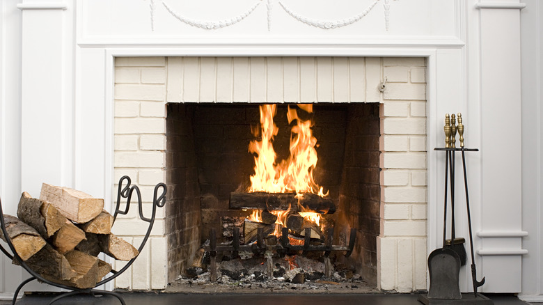 white brick fireplace and logs