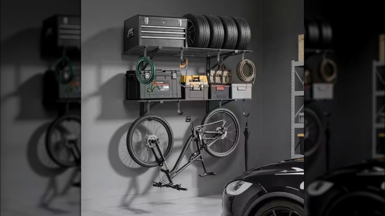 Vevor's 2-Tier Wall Garage Shelving with Hooks, loaded with tool chests plus a bike hanging underneath