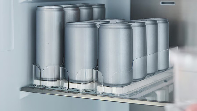 The KLIPPKAKTUS drink holder with silver cans on the shelf of a refrigerator