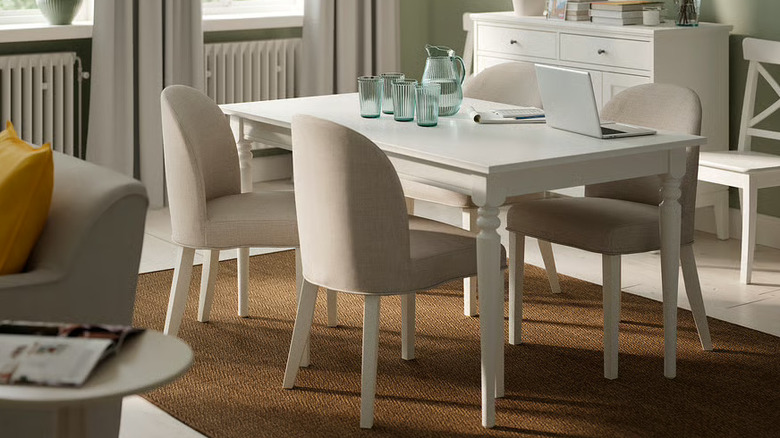 Four ROSENTORP chairs around a white kitchen table in a home