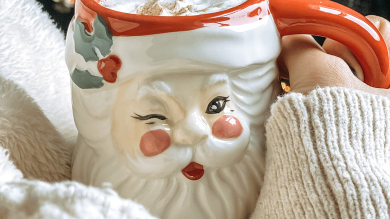 Person holding vintage santa mug