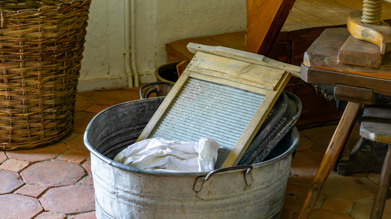 An old washboard in a large metal bowl