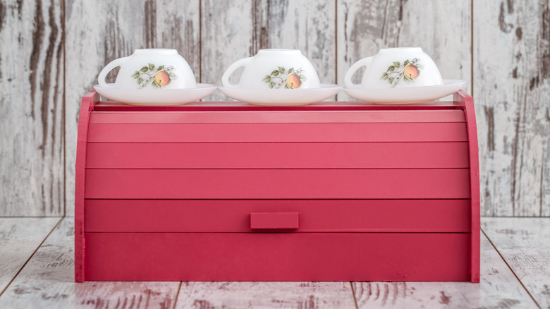 A vintage pink wooden bread box