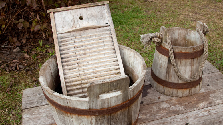 A washboard inside a wooden water pail